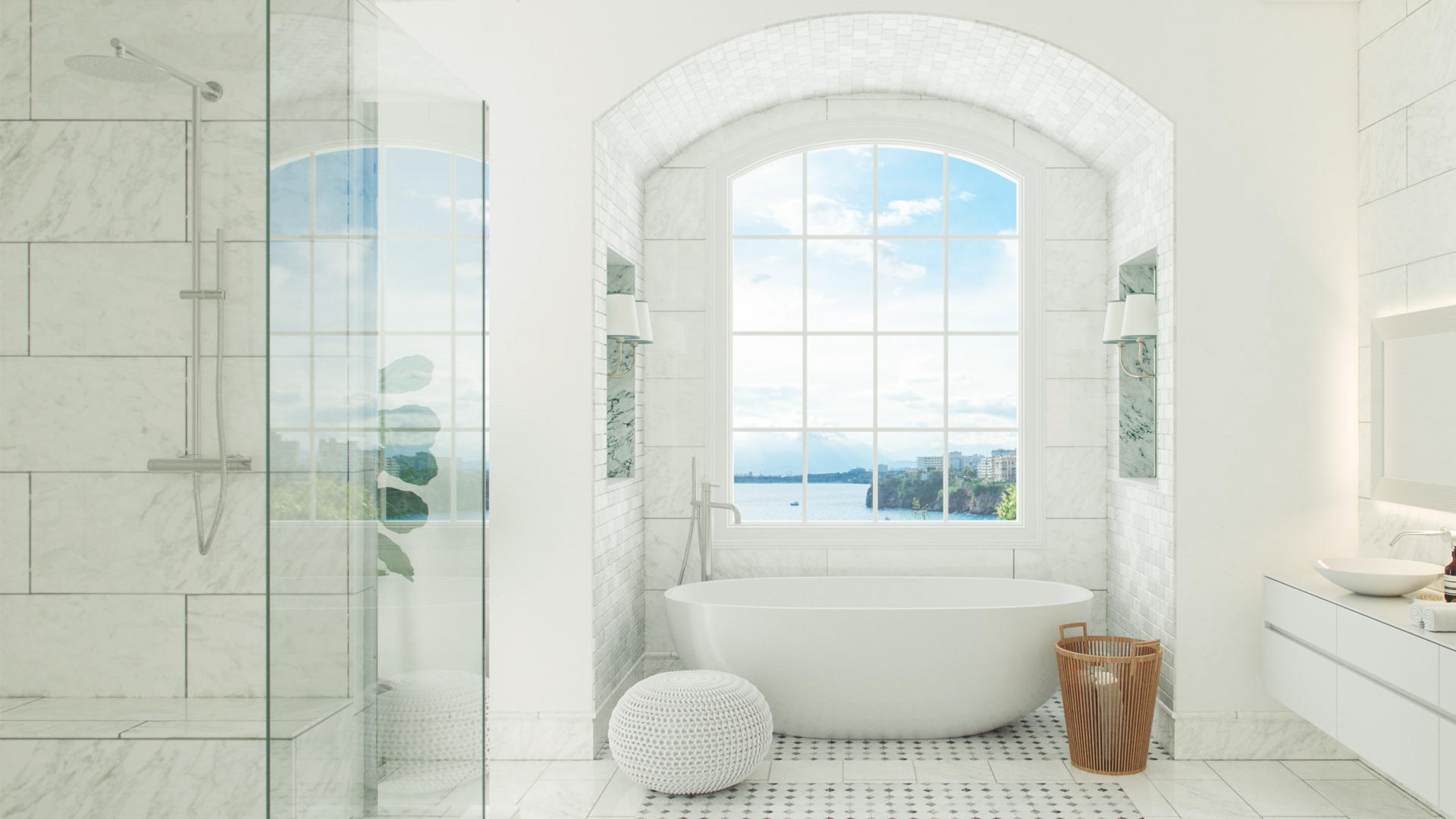 Baño luminoso con bañera exenta, ducha acristalada y gran ventanal con vistas al mar